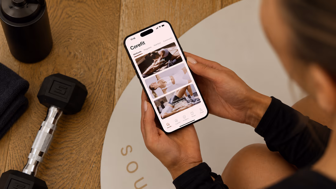 Hands holding a phone with the CoreFit app open